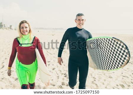 Similar – Image, Stock Photo Content female surfer walking on beach with surfboard