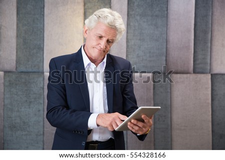 Similar – Image, Stock Photo Puzzled senior businessman in stylish formal wear at shopping plaza