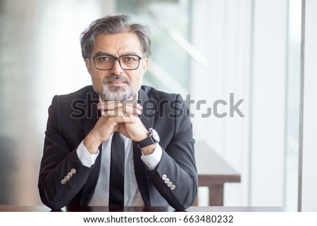 Similar – Image, Stock Photo Pensive senior male sitting on floor with cup of tea