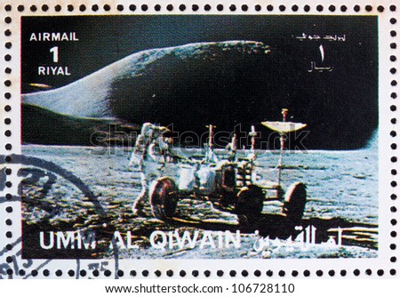 UMM AL-QUWAIN - CIRCA 1972: a stamp printed in the Umm al-Quwain shows Astronaut James Irwin works on the Lunar Roving Vehicle, Moon-landing, Apollo 15, circa 1972