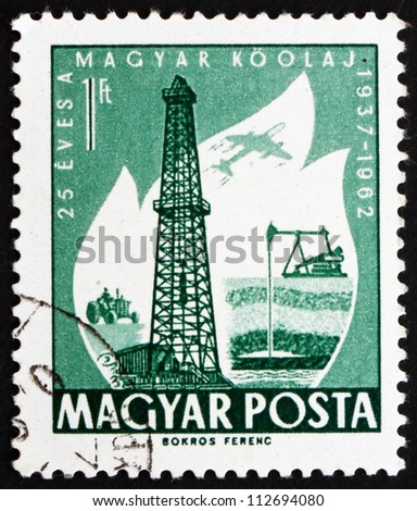 HUNGARY - CIRCA 1962: a stamp printed in the Hungary shows Oil Derrick and Primitive Oil Well, 25th Anniversary of the Hungarian Oil Industry, circa 1962