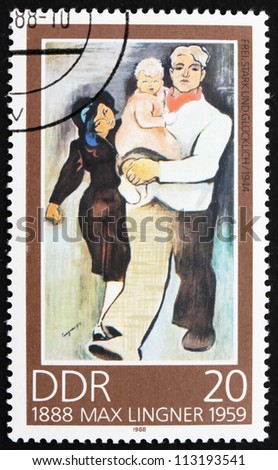 GDR - CIRCA 1988: a stamp printed in GDR shows Free, Strong and Happy, Painting by Max Lingner, circa 1988