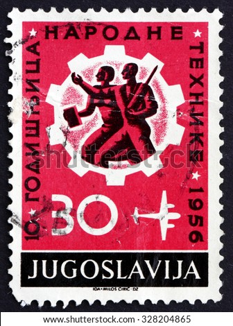 YUGOSLAVIA - CIRCA 1956: a stamp printed in the Yugoslavia shows Workers and Cogwheel, 10th Anniversary of Technical Education, circa 1956