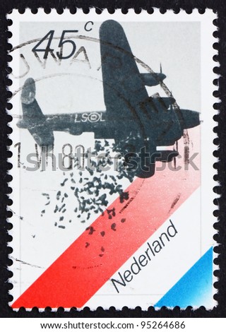 NETHERLANDS - CIRCA 1988: a stamp printed in the Netherlands shows British Bomber Dropping Food, Dutch Flag, 35th Anniversary of Liberation from Germans, circa 1988