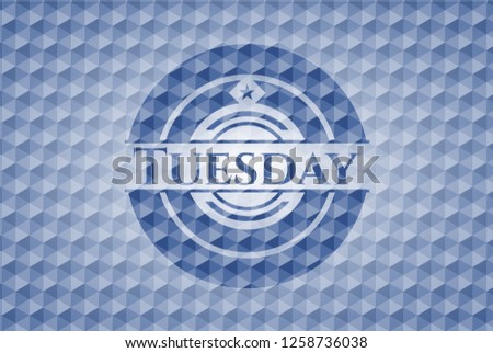 Tuesday blue badge with geometric pattern.