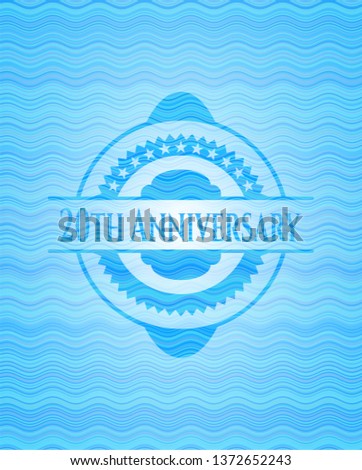 20th Anniversary light blue water style badge.