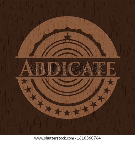 Abdicate badge with wooden background