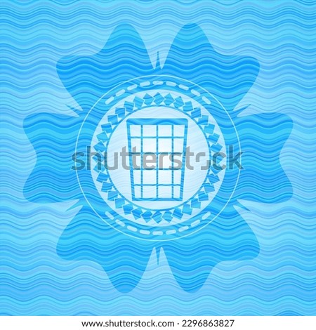 wastepaper basket icon inside water wave representation emblem. 