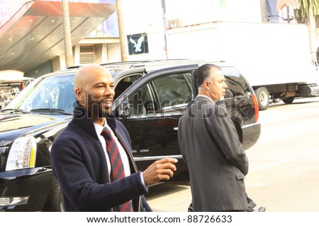 HOLLYWOOD, CA - NOVEMBER 13:  Rapper Common is going over to fans to sign their posters outside Grauman\'s Chinese Theatre at the premiere of the movie Happy Feet on November 13, 2011 in Hollywood, CA.