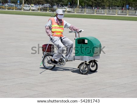 Street cleaner on bike and with protective respiratory mask