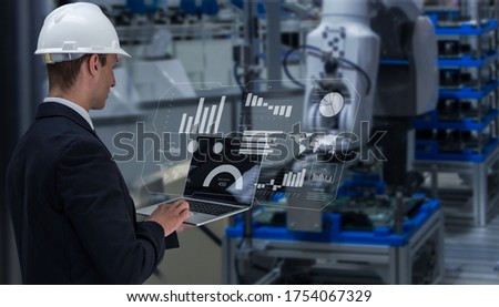 Industry 4.0 Robot concept .Engineers use laptop computers for machine maintenance, automation tools, robot arm at the factory. 商業照片 © 