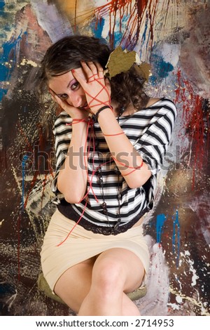 Young brunette woman leisure in art studio on abstract backgrounds