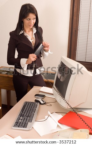 Young pretty business woman in everyday job at office