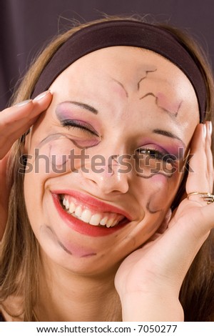 Beautiful young brunette smiling woman with drawing face