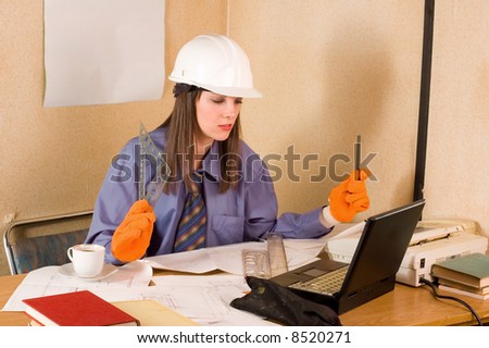 Woman engineer with helmet and glove and arch project at table