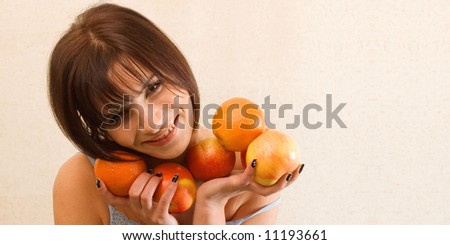 Young happy woman holding fruits to have a nice shape
