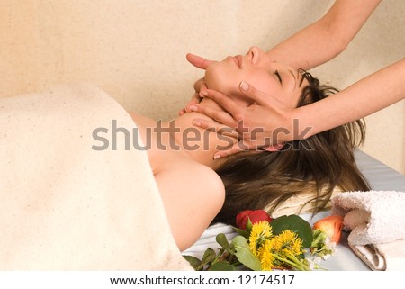 Young woman getting a massage on head and neck, lying down