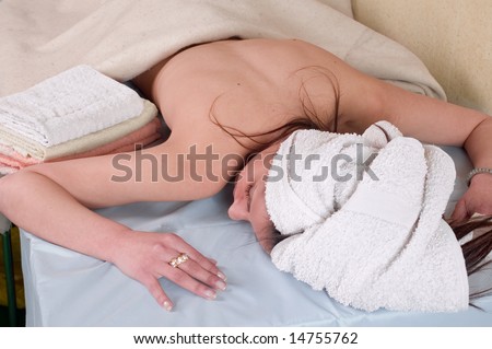 Young woman lying on stomach for treatment at a spa