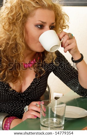 Blonde girl with curly hair drinking coffee and smoking