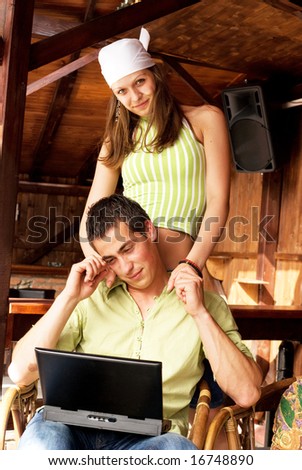 Young man and woman in restaurant with laptop