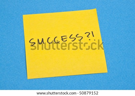 What is success?  Question on yellow note on blue background.