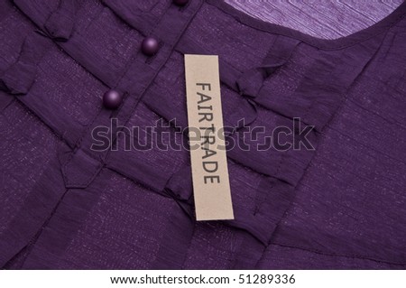 Fair Trade Clothing Concept Image with Purple Shirt Detail.