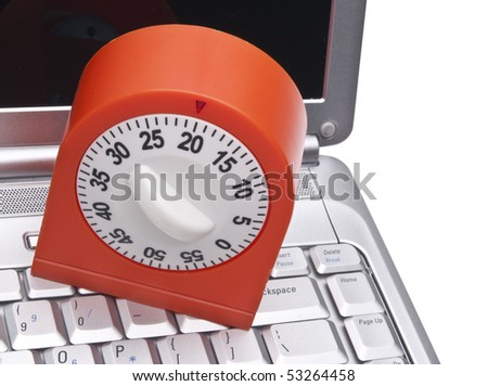 Time on the Internet Concept with Keyboard and Kitchen Timer.  Monitoring How Much Time You Spend Online.