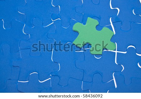 A puzzle is missing two pieces to be completed in different colors. white  pieces and one piece in green and one in orange to add text Stock Photo -  Alamy