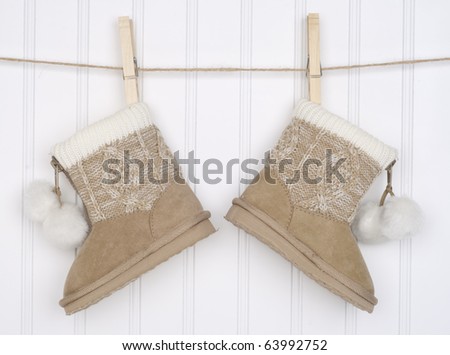 Pair of Winter Boots Hanging from a Clothesline.