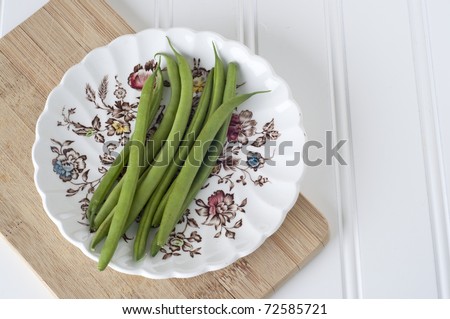 French Style String Beans on Delicate Floral Plate with Wooden Board.