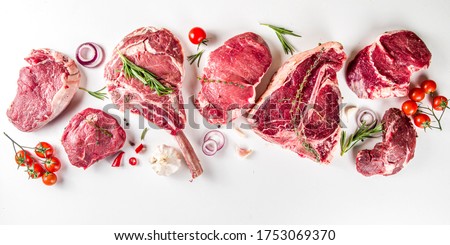 Set of various classic, alternative raw meat, veal beef steaks - chateau mignon, t-bone, tomahawk, striploin, tenderloin, new york steak. Flat lay top view on white table background