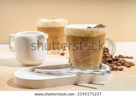 Cold dairy coffee drink with milk, whipped cream. Foamy frappe, latte, cappuccino, on a cream background, space for text. Summer cold coffee cocktail Photo stock © 