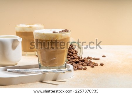 Cold dairy coffee drink with milk, whipped cream. Foamy frappe, latte, cappuccino, on a cream background, space for text. Summer cold coffee cocktail Foto d'archivio © 