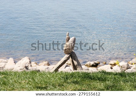 Stone pile of natural stone, water surface in background