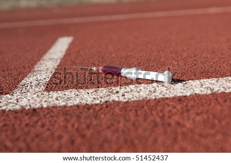 Doping syringe on athletics sports area