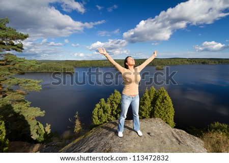 Young brunette at meditation in idyllic scenery of Sweden
