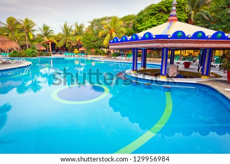 PLAYA DEL CARMEN, MEXICO - JULY 12, 2011: Scenery of luxury swimming pool at RIU Yucatan Hotel on July 12, 2011 in Playa del Carmen. RIU Hotels & Resorts has more than 100 hotels in 19 countries.