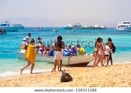 AL-MAHMYA ISLAND, EGYPT - APR 8, 2013: Unidentified people coming on the boat to the paradise island on 8 Apr 2013. Al-Mahmya is a National Park with paradise beach and big tourist attraction of Egypt