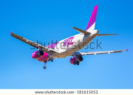 GDANSK AIRPORT, POLAND - 13 MAR: Wizz air plane landing on Lech Walesa Airport in Gdansk on March 13, 2014. Wizz air is a low-cost airline with largest fleet in Hungary who serves over 30 countries.