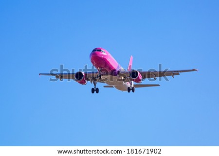 GDANSK AIRPORT, POLAND - 13 MAR: Wizz air plane landing on Lech Walesa Airport in Gdansk on March 13, 2014. Wizz air is a low-cost airline with largest fleet in Hungary who serves over 30 countries.