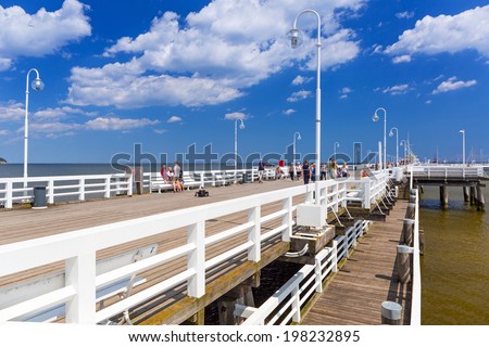 SOPOT, POLAND - 7 JUNE: People on Sopot molo at Baltic Sea, 7 June 2014. Sopot is major health and tourist resort destination and this pier with 511.5 meters long is the longest wooden pier in Europe.