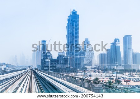 DUBAI, UAE - MARCH 31: Metro line in Dubai on March 31, 2014, UAE. The Dubai Metro is a driverless, fully automated metro rail network in the city of Dubai and carry over 180,000 passengers every day.