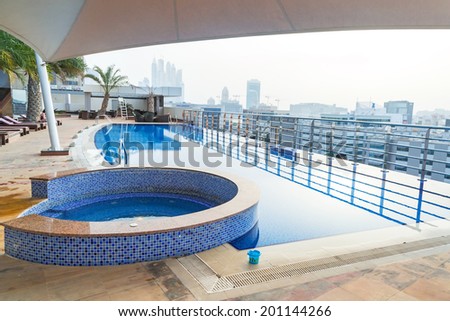 DUBAI, UAE - 31 MARCH 2014: Pool area of The Grand Midwest Tower Hotel in Dubai, UAE. The Grand Midwest Group owns 4 hotels in Dubai with over 700 rooms.