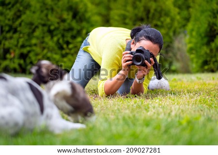 Young photographer taking a photo of playing dogs