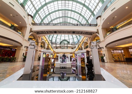 DUBAI, UAE - 3 APRIL 2014: People walking in Mall of the Emirates in Dubai, UAE. Mall of the Emirates is multi-level shopping centre with over 700 stores and Ski Dubai - first indoor ski resort.