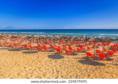 LAGANAS, GREECE - AUG 23, 2015: Umbrellas and sundecks of the sandy Banana Beach on Zakynthos, Greece. Banana is the largest beach of Zakynthos island.