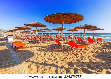 LAGANAS, GREECE - AUG 23, 2015: Umbrellas and sundecks of the sandy Banana Beach on Zakynthos, Greece. Banana is the largest beach of Zakynthos island.