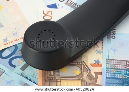 black telephone\'s receiver on money background