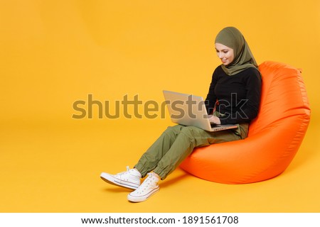 Similar – Image, Stock Photo Cheerful Arab woman with headphones on embankment