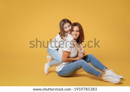 Similar – Image, Stock Photo Mother and daughter sit in the Lotus position in the garden. The family practices yoga outdoors. Back view, space for text